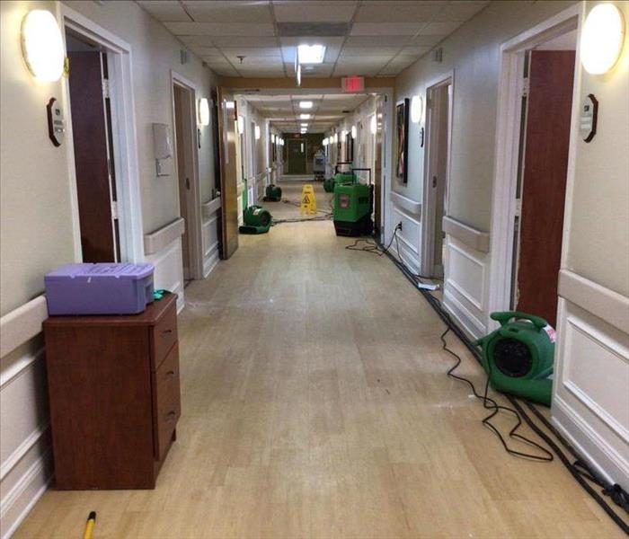 medical facility hallway with green water drying equipment